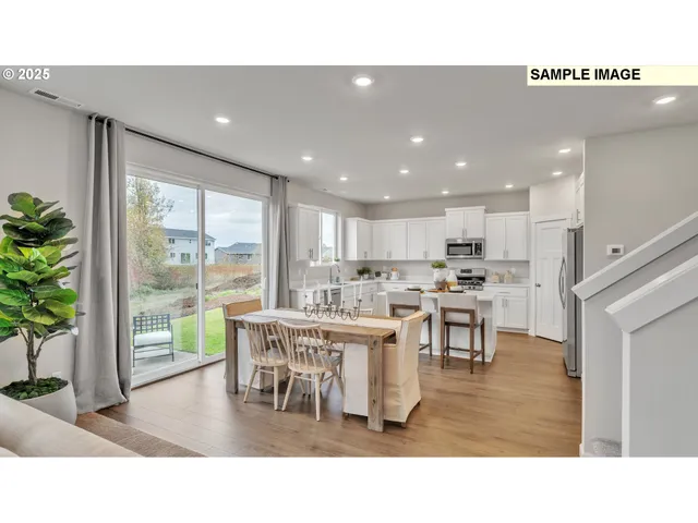 a living room with stainless steel appliances kitchen island granite countertop furniture and a dining table