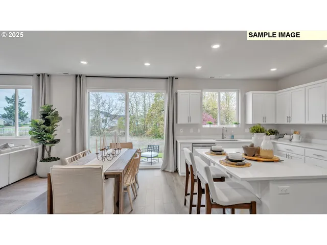 a kitchen with a table chairs and wooden floor