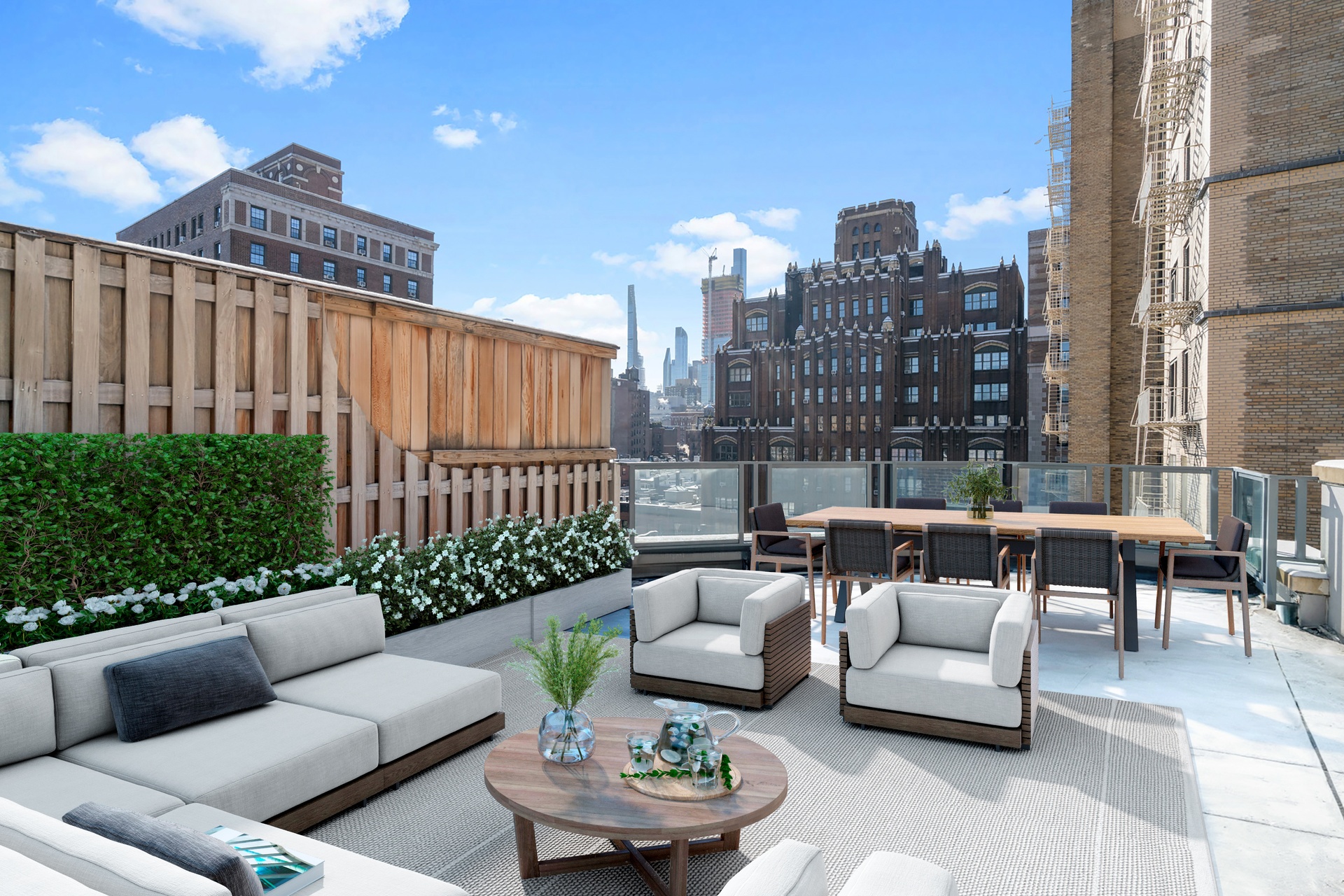 a roof deck with couches and a potted plant on a table