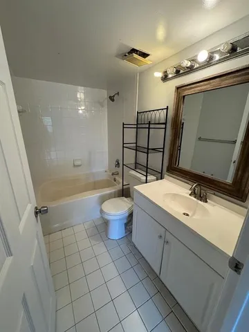 a view of a livingroom with a ceiling fan and entryway
