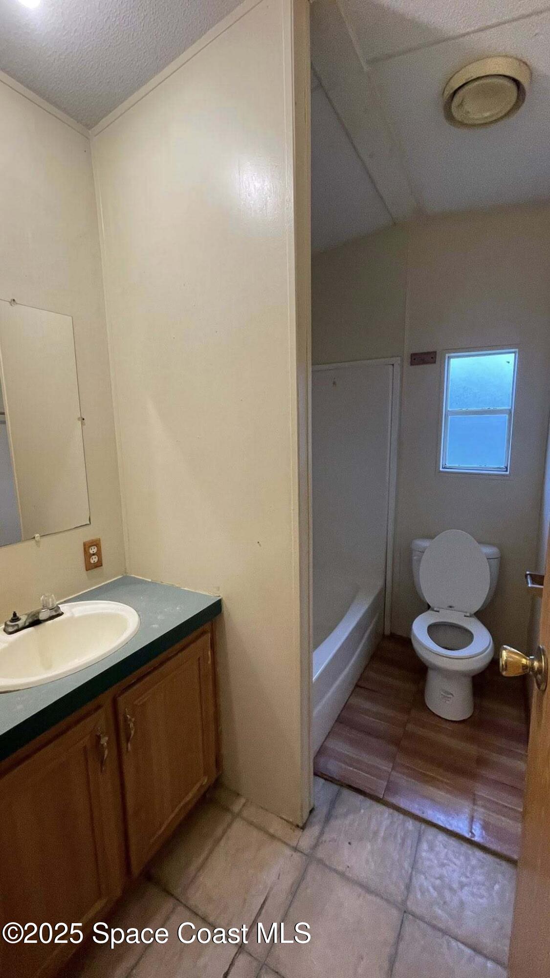 54275 Bea Road Callahan, FL 32011 - Photo 29 of 52 a bathroom with a granite countertop sink and a toilet
