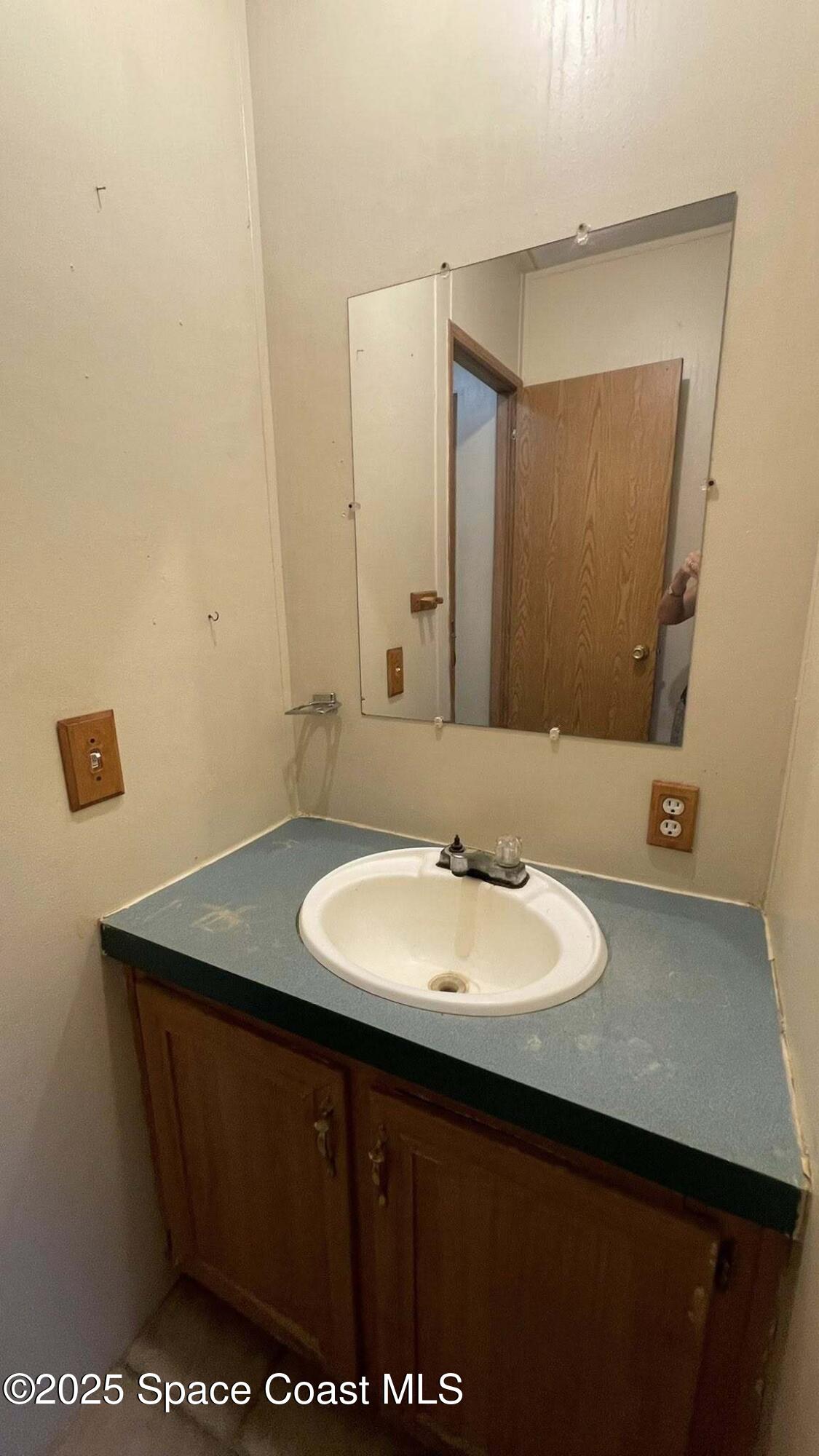 54275 Bea Road Callahan, FL 32011 - Photo 31 of 52 a bathroom with a sink a mirror and a toilet