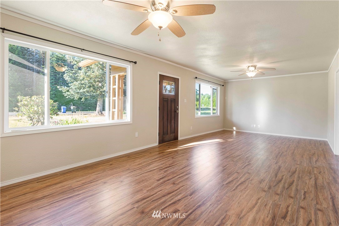 10101 James Road Southwest Rochester, WA 98579 - Photo 11 of 34 a view of an empty room with wooden floor and a window