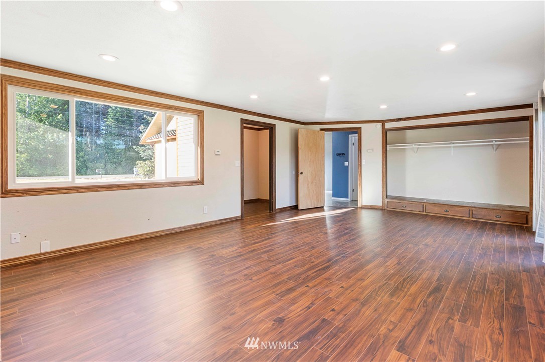 10101 James Road Southwest Rochester, WA 98579 - Photo 16 of 34 a view of an empty room with wooden floor and a window