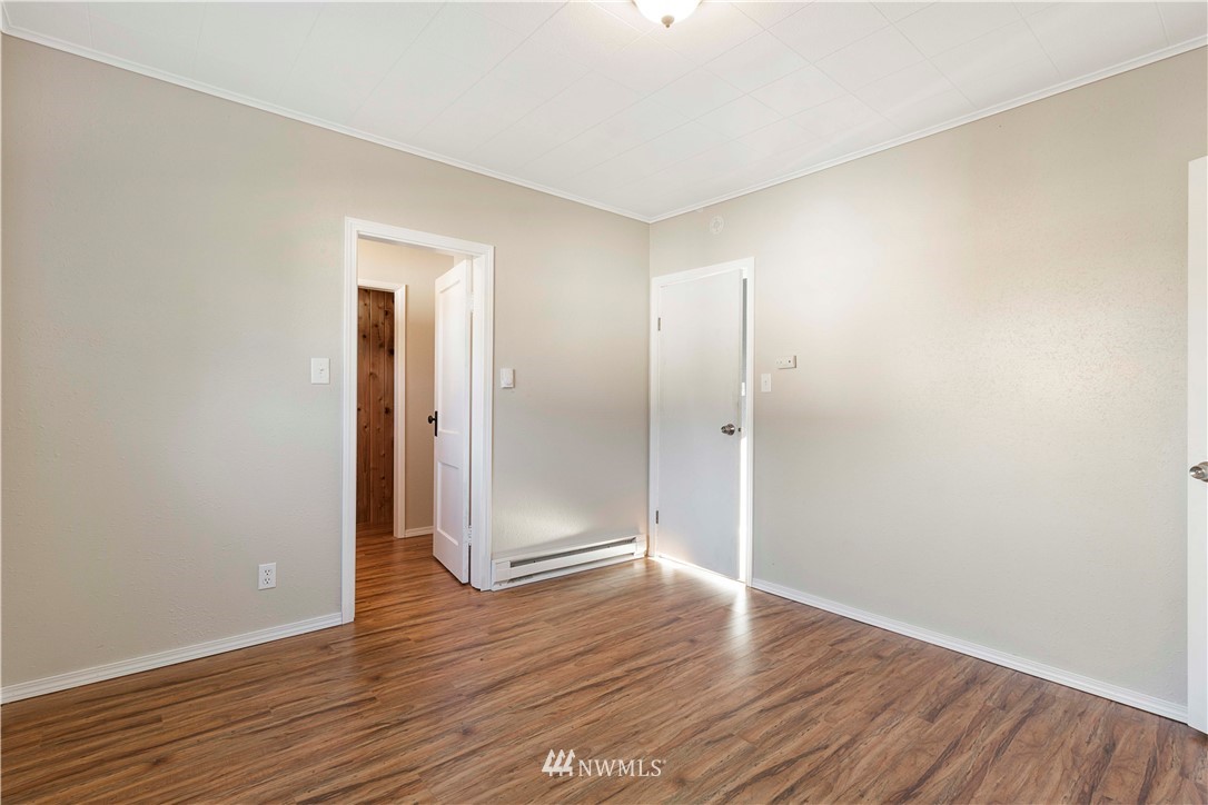 10101 James Road Southwest Rochester, WA 98579 - Photo 20 of 34 a view of an empty room with wooden floor