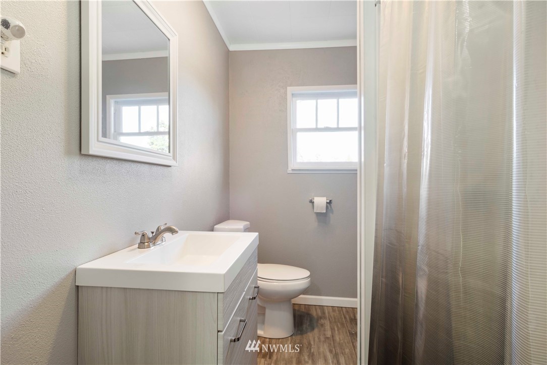 10101 James Road Southwest Rochester, WA 98579 - Photo 24 of 34 a bathroom with a sink a toilet and a window