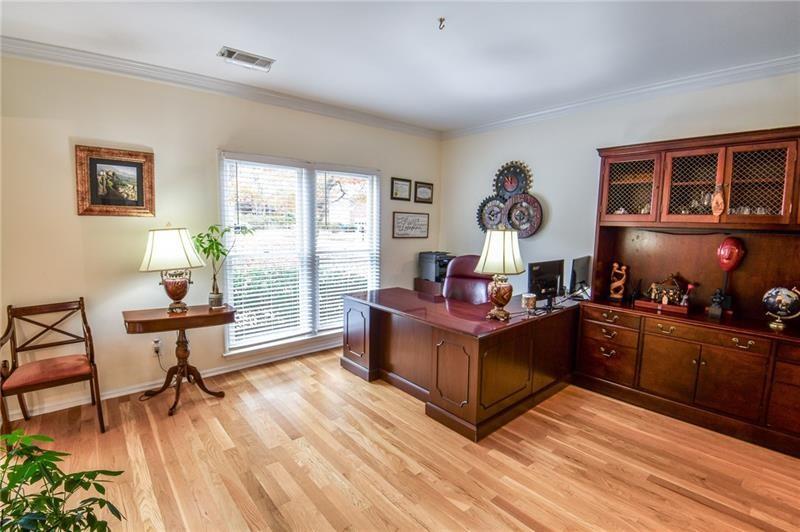 1865 Oak Tree Hollow Alpharetta, GA 30005 - Photo 11 of 35 a bed room with furniture and a window