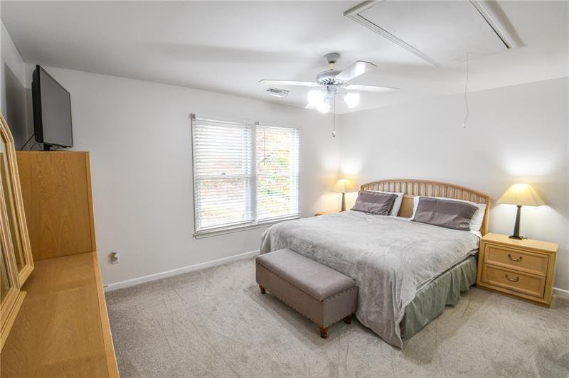 1865 Oak Tree Hollow Alpharetta, GA 30005 - Photo 19 of 35 a bed room with a bed and a television