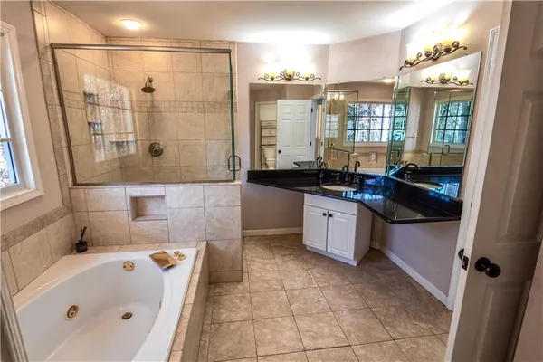 a bathroom with a sink double vanity and a shower