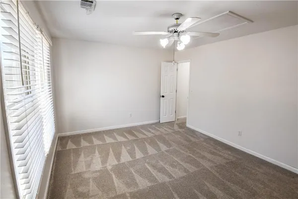 a large kitchen with granite countertop a sink a stove cabinets and wooden floor