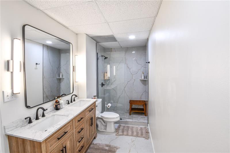 1865 Oak Tree Hollow Alpharetta, GA 30005 - Photo 25 of 35 a bathroom with a double vanity sink toilet mirror and shower