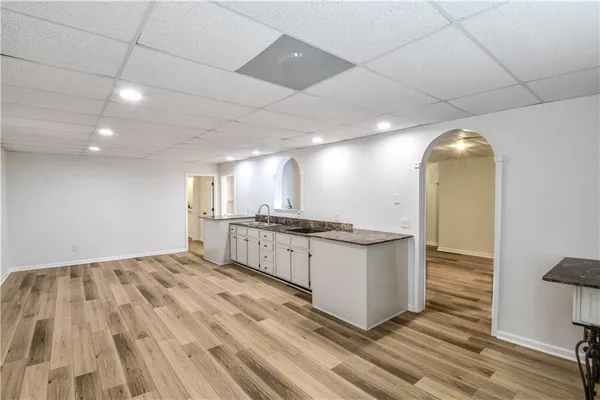 a view of a patio with table and chairs with wooden floor and fence