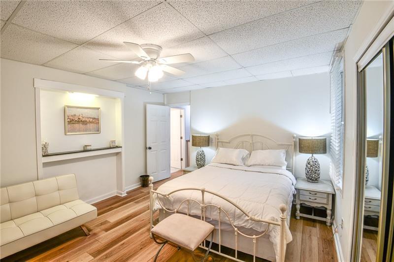 1865 Oak Tree Hollow Alpharetta, GA 30005 - Photo 27 of 35 a bedroom with a bed and a couch