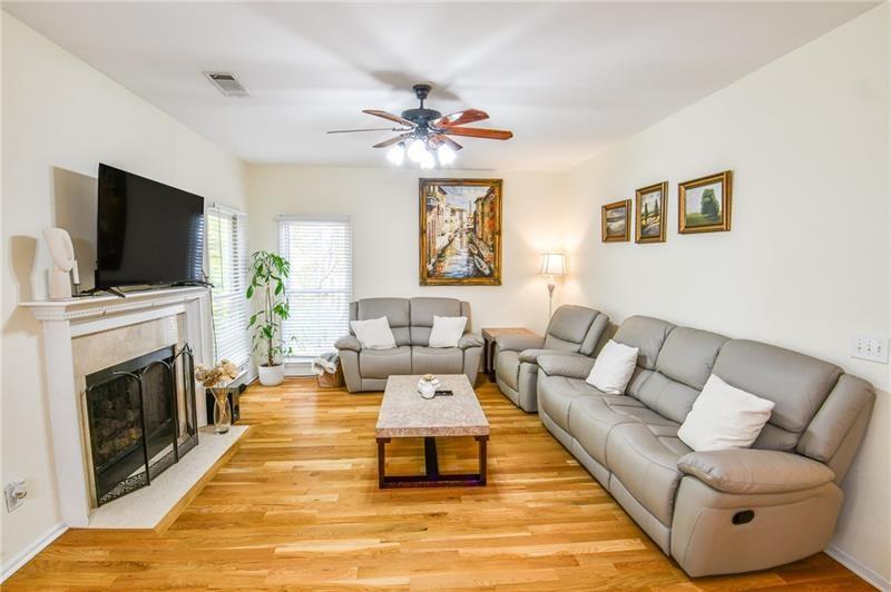 1865 Oak Tree Hollow Alpharetta, GA 30005 - Photo 3 of 35 a living room with furniture a fireplace and a flat screen tv