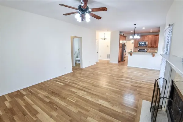 a view of a staircase with wooden floor and white walls