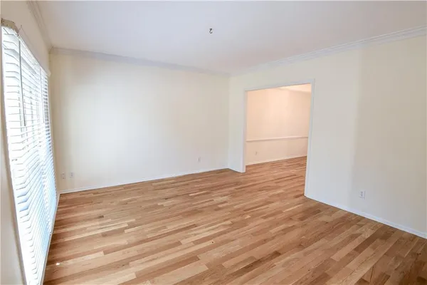 a view of a room with window and wooden floor