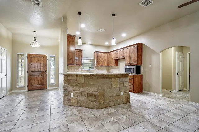 a kitchen with stainless steel appliances granite countertop wooden cabinets a sink and dishwasher