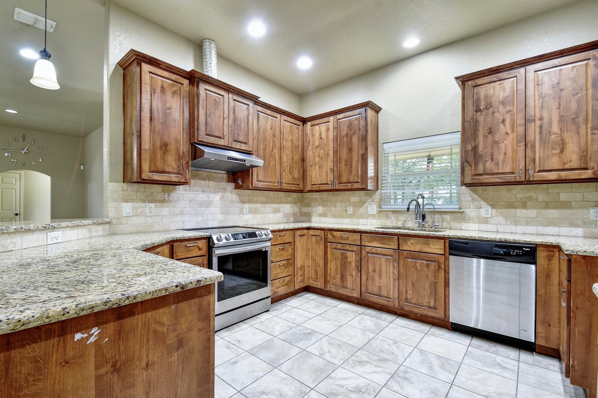 158 Pullman Road La Vernia, TX 78121 - Photo 13 of 39 a kitchen with stainless steel appliances granite countertop wooden cabinets a sink and dishwasher