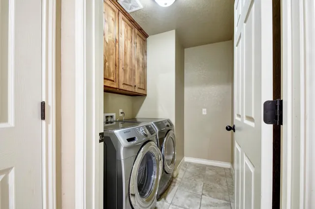 a bathroom with a granite countertop sink two mirror and a shower