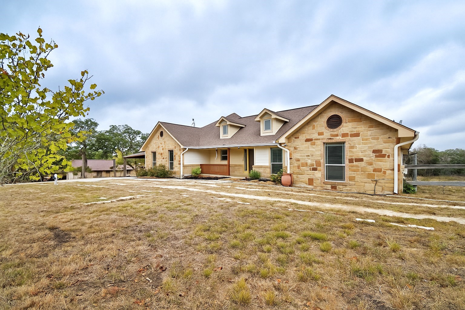 158 Pullman Road La Vernia, TX 78121 - Photo 2 of 39 a front view of a house with a garden