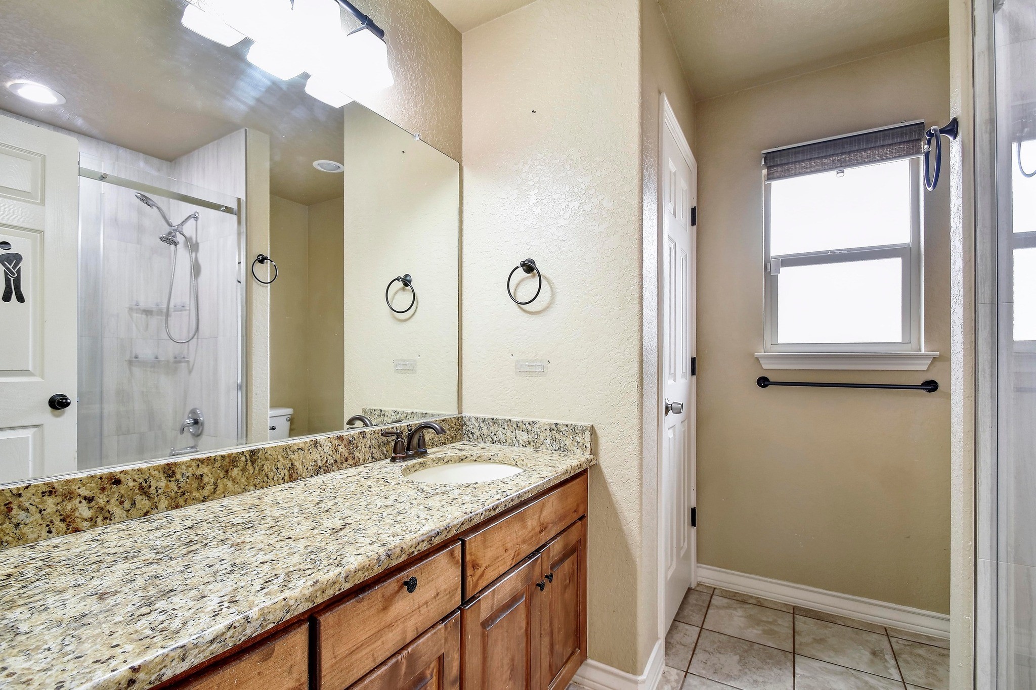 158 Pullman Road La Vernia, TX 78121 - Photo 24 of 39 a bathroom with a granite countertop sink and a mirror