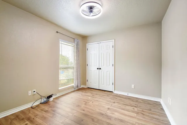 a living room with furniture a flat screen tv and a large window
