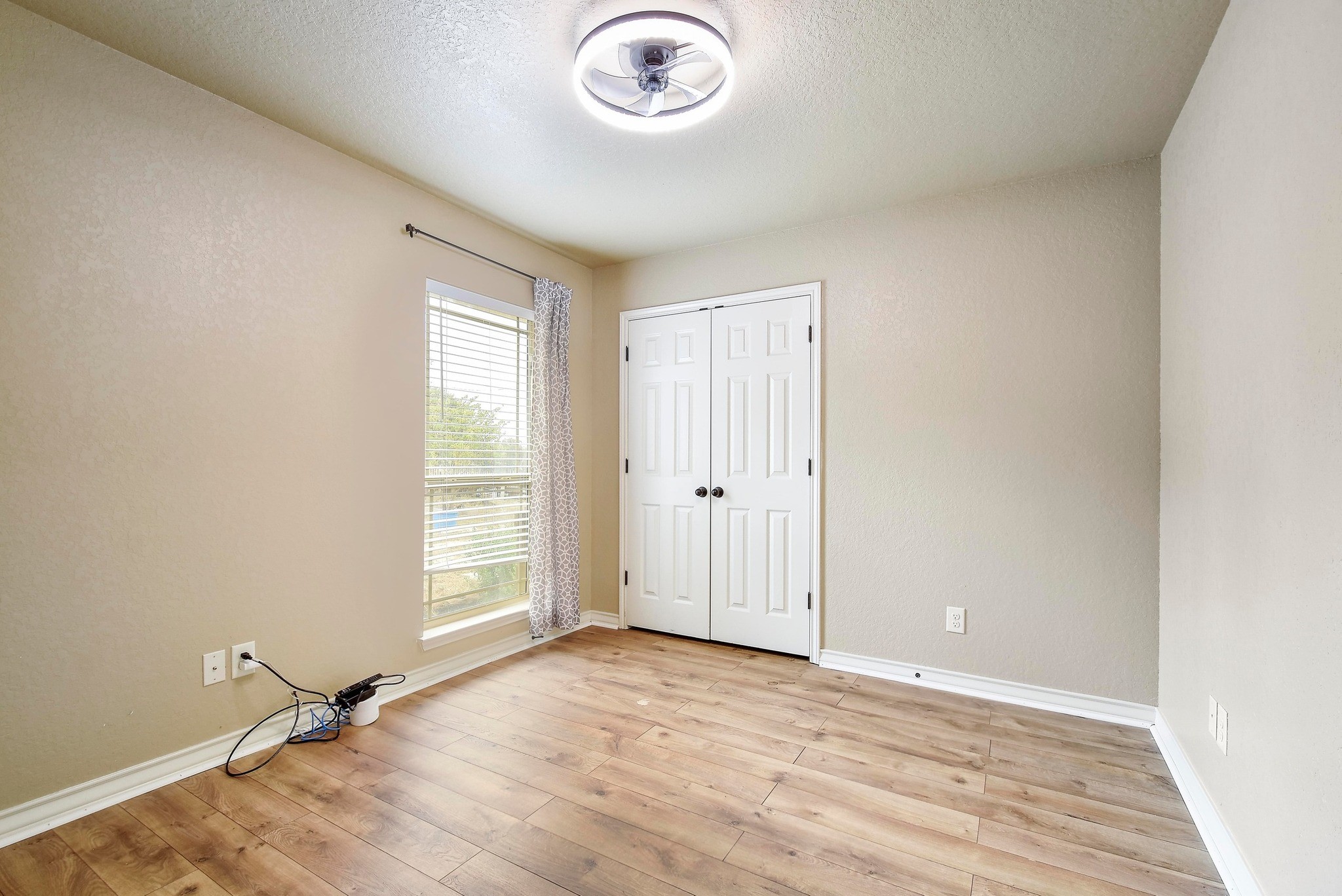 158 Pullman Road La Vernia, TX 78121 - Photo 25 of 39 an empty room with a window and a ceiling fan