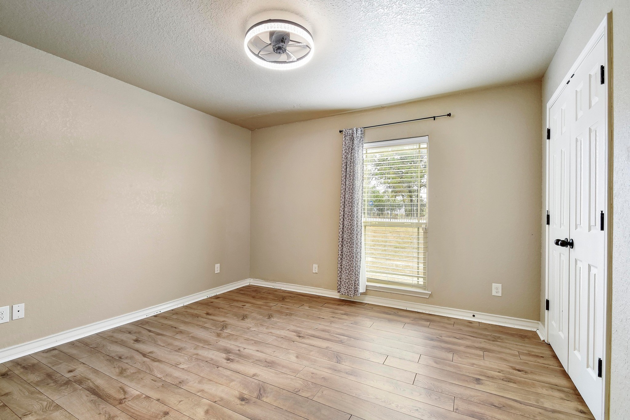 158 Pullman Road La Vernia, TX 78121 - Photo 27 of 39 an empty room with wooden floor and windows