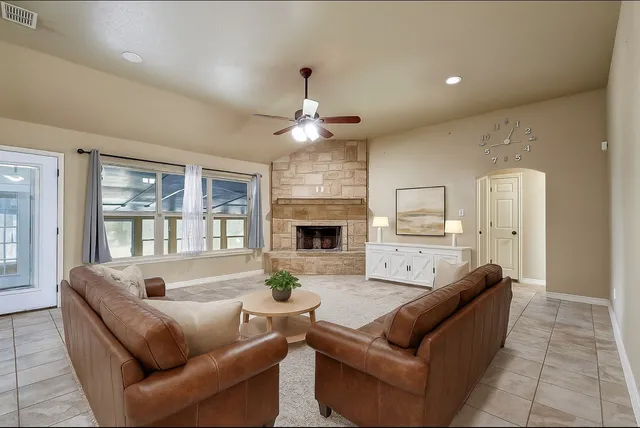 a view of an empty room with a fireplace and a window