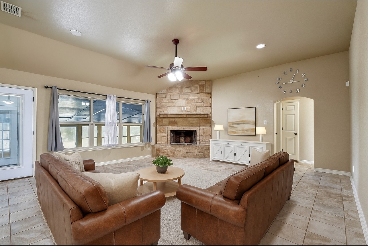 158 Pullman Road La Vernia, TX 78121 - Photo 6 of 39 a living room with furniture a fireplace and a chandelier