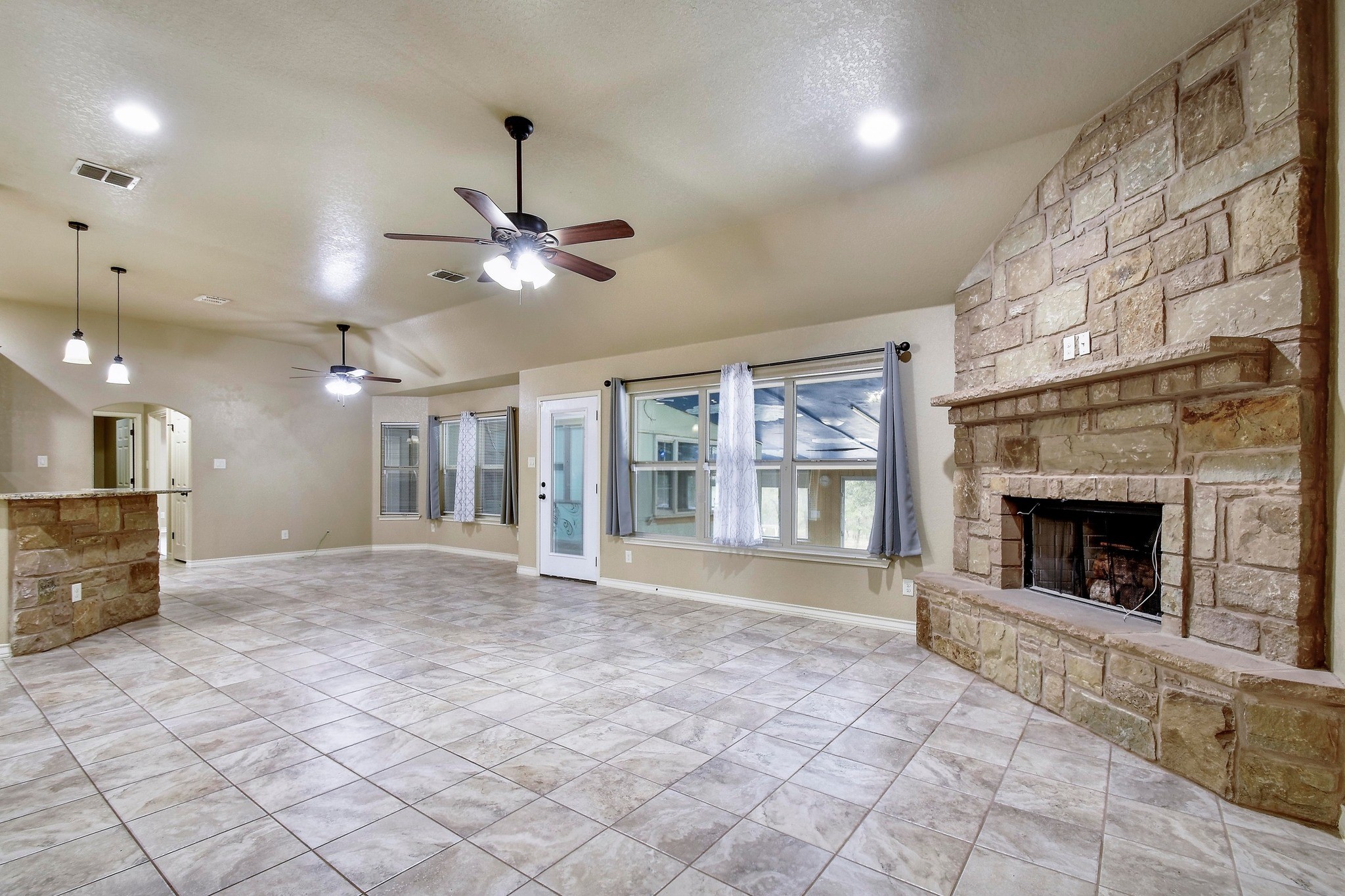 158 Pullman Road La Vernia, TX 78121 - Photo 7 of 39 a view of an empty room with a fireplace and a window