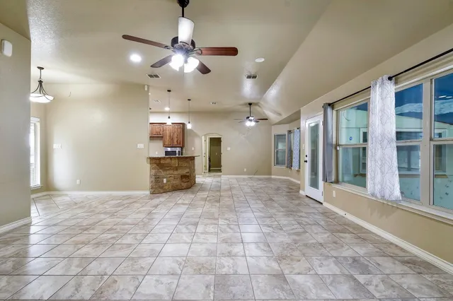 a view of an empty room with a fireplace