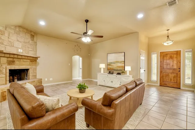 a large kitchen with stainless steel appliances kitchen island granite countertop a refrigerator and a sink