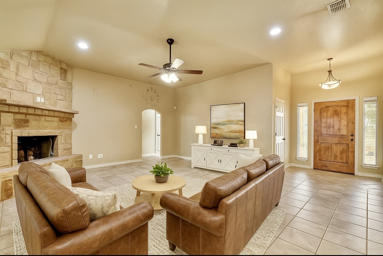 158 Pullman Road La Vernia, TX 78121 - Photo 10 of 39 a living room with furniture and a fireplace