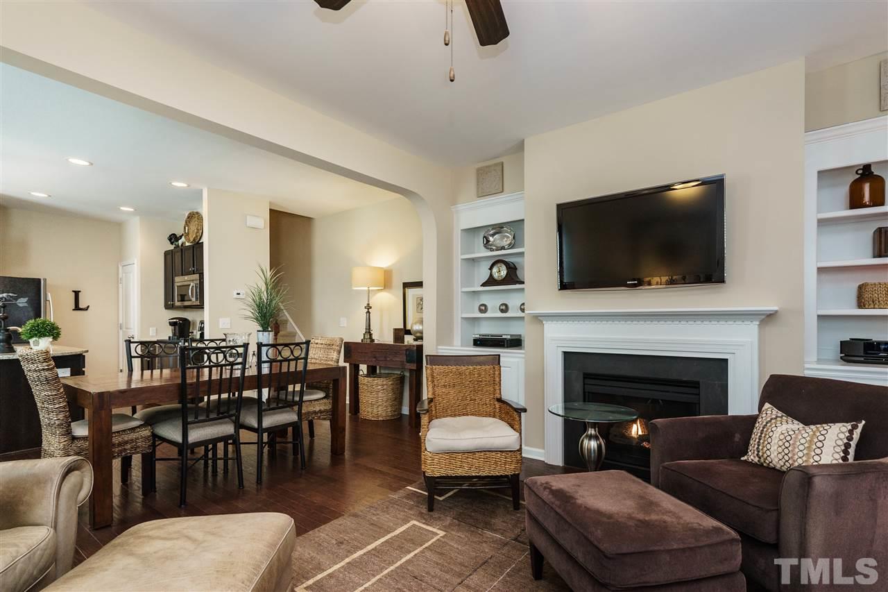 756 Wickham Ridge Road Apex, NC 27539 - Photo 8 of 25 a living room with furniture fireplace and a flat screen tv