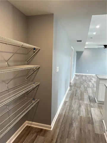 an empty room with wooden floor and closet