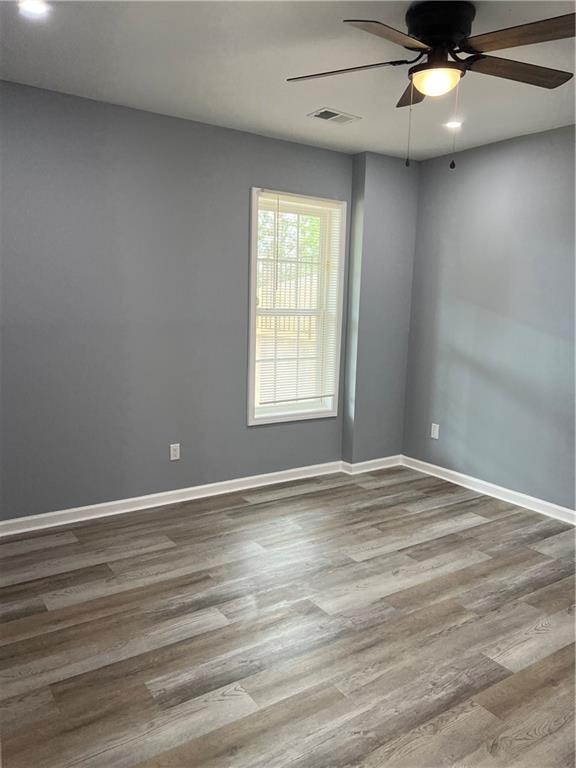 3152 Daleview Way Southwest Atlanta, GA 30331 - Photo 22 of 35 an empty room with wooden floor and windows