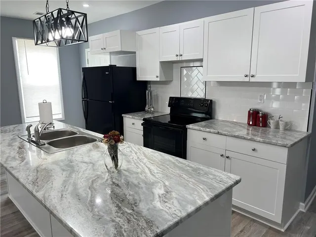 a bathroom with a granite countertop sink a mirror and a vanity