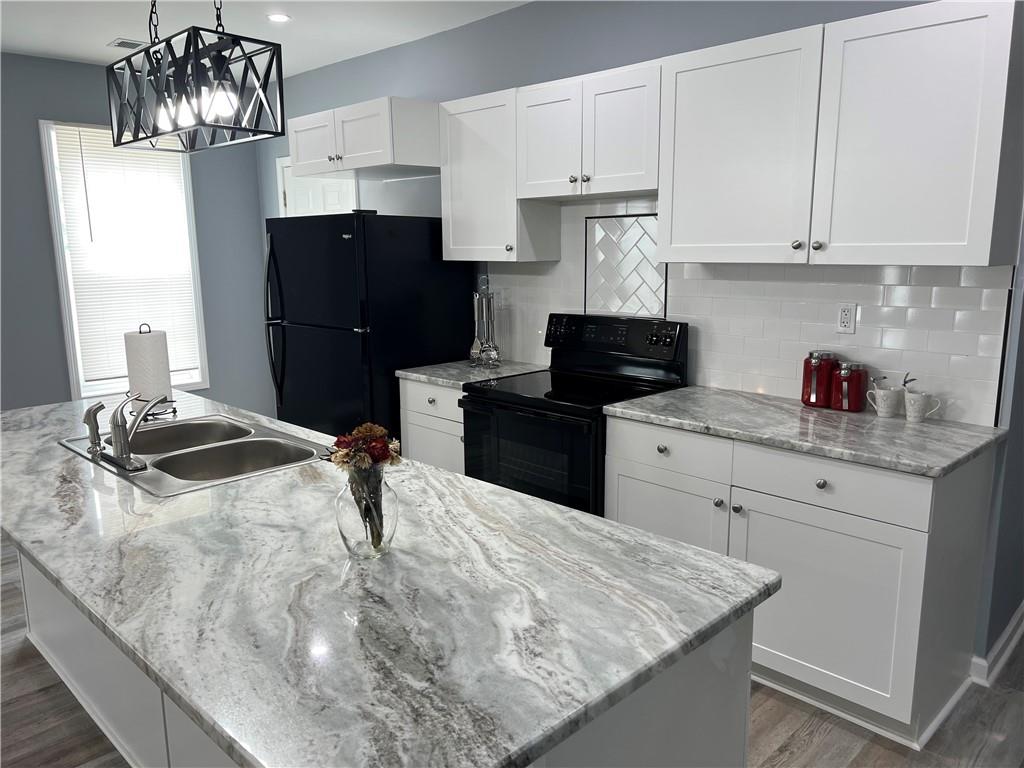 3152 Daleview Way Southwest Atlanta, GA 30331 - Photo 10 of 35 a kitchen with stainless steel appliances granite countertop a sink stove and refrigerator