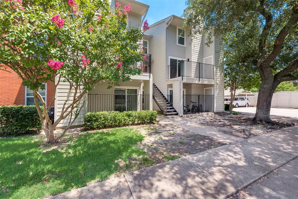 6900 Skillman Street, Unit 101 Dallas, TX 75231 - Photo 1 of 1 a front view of a house with a yard and large tree