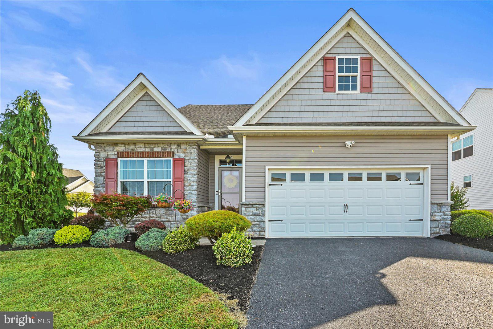 80 Evan Drive York, PA 17404 - Photo 1 of 37 a front view of a house with a garden and plants