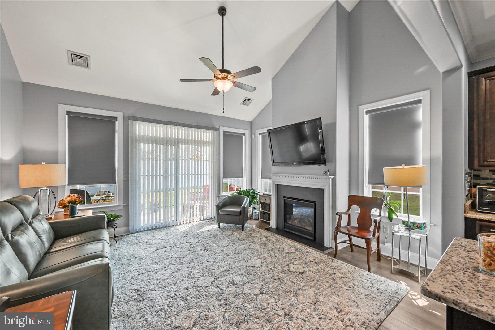 80 Evan Drive York, PA 17404 - Photo 13 of 37 a living room with furniture a fireplace and a flat screen tv