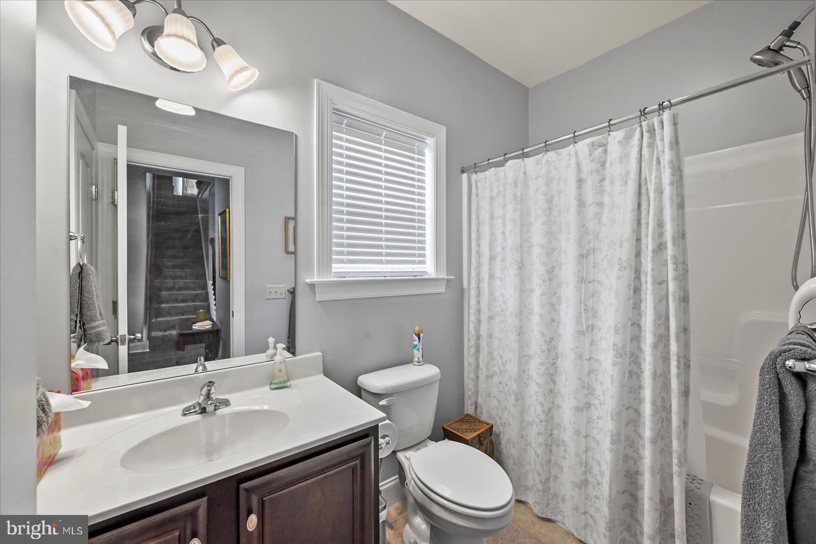 80 Evan Drive York, PA 17404 - Photo 15 of 37 a bathroom with a sink a toilet and shower curtain