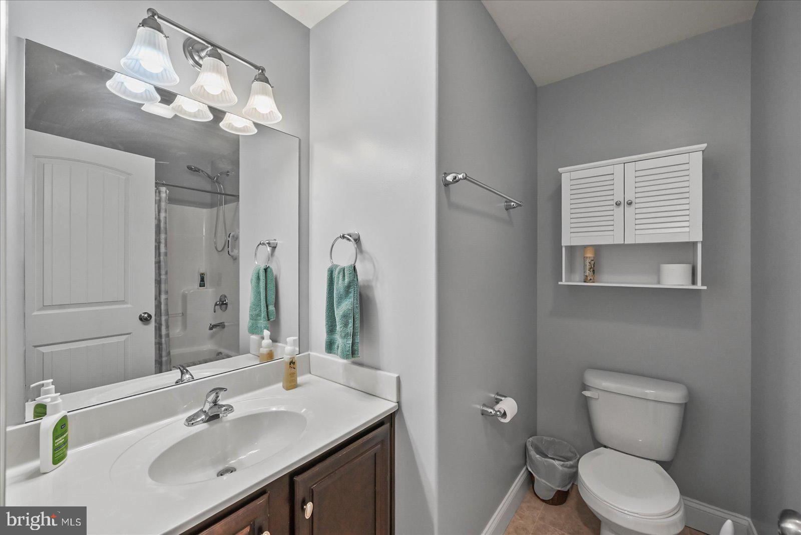 80 Evan Drive York, PA 17404 - Photo 25 of 37 a bathroom with a toilet a sink a large mirror and vanity