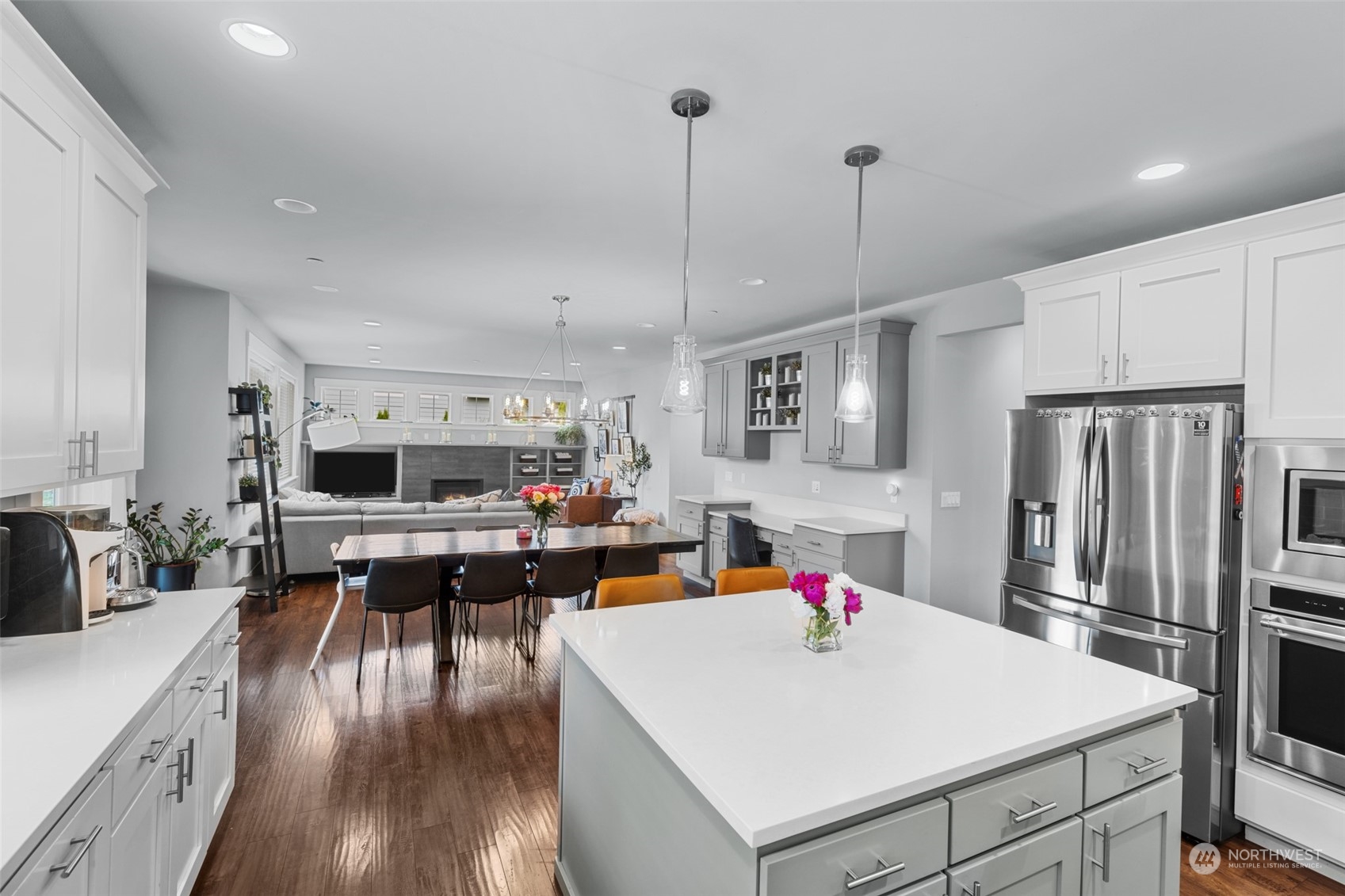 21815 86th Place West Edmonds, WA 98026 - Photo 11 of 25 a very nice looking open kitchen with stainless steel appliances granite countertop a refrigerator a stove a sink dishwasher and a dining table with wooden floor