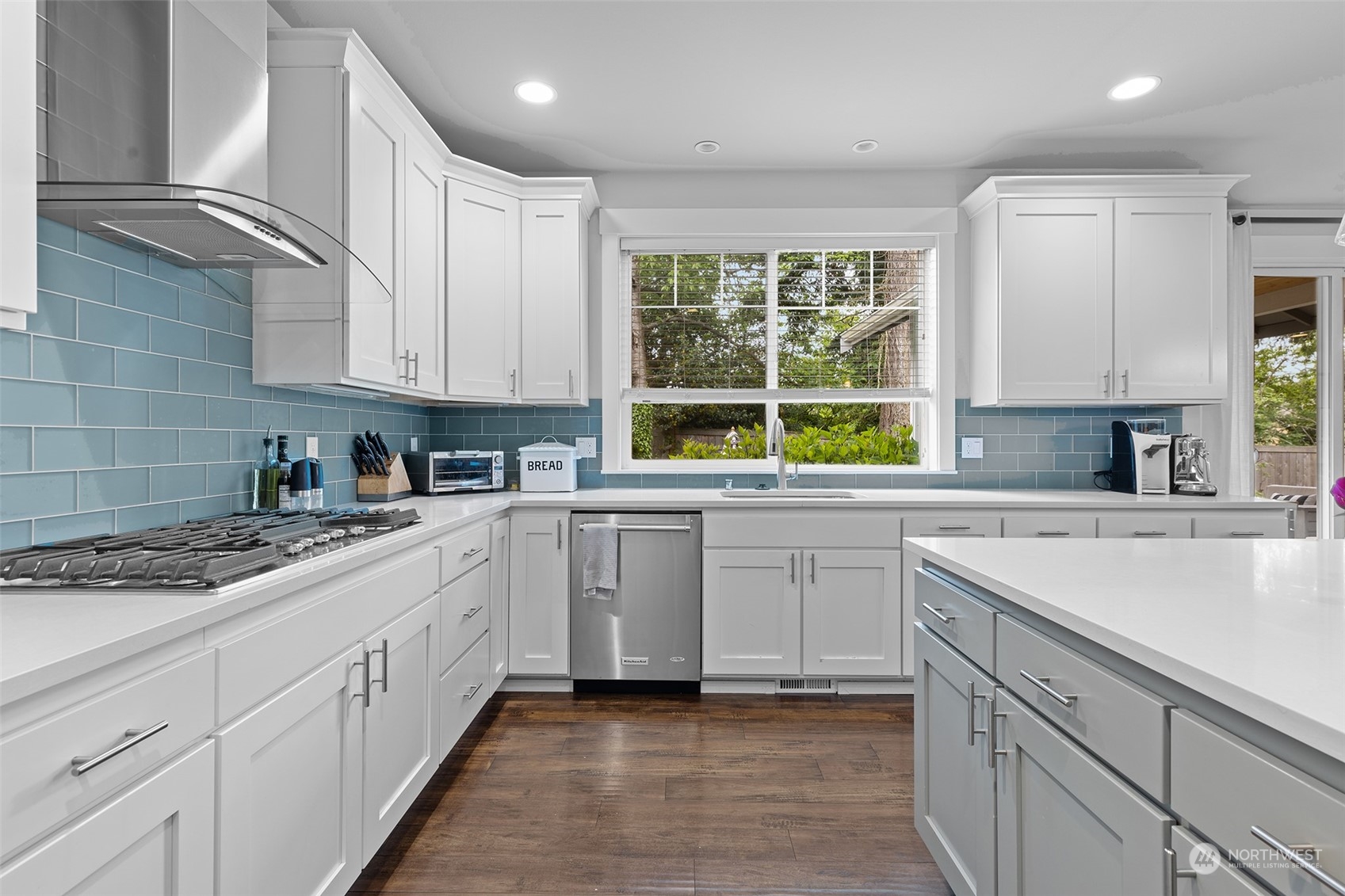 21815 86th Place West Edmonds, WA 98026 - Photo 10 of 25 a kitchen with kitchen island granite countertop white cabinets white appliances a sink and a window