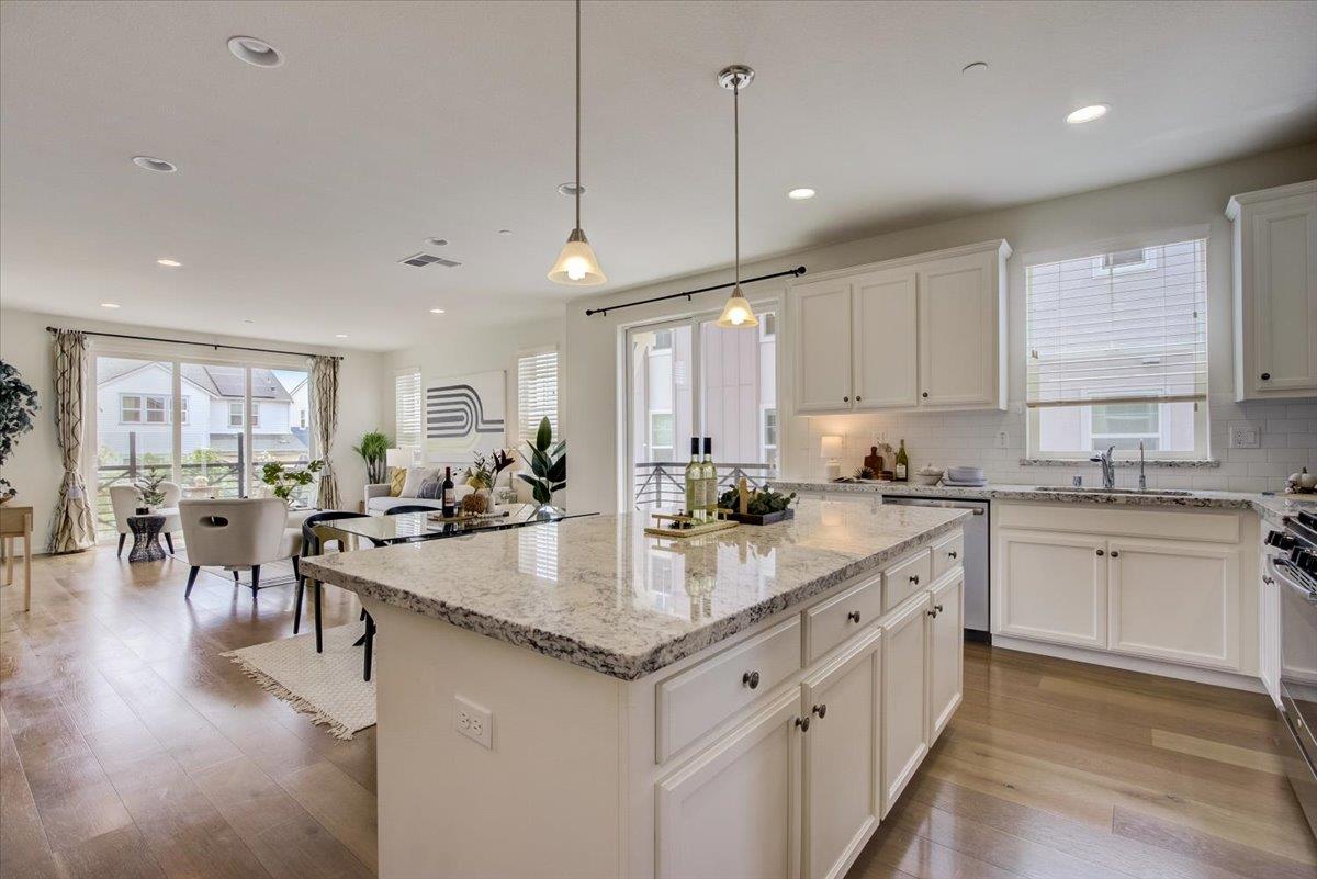 4132 Panorama Drive Dublin, CA 94568 - Photo 14 of 53 a large kitchen with kitchen island a large center island white cabinets and stainless steel appliances