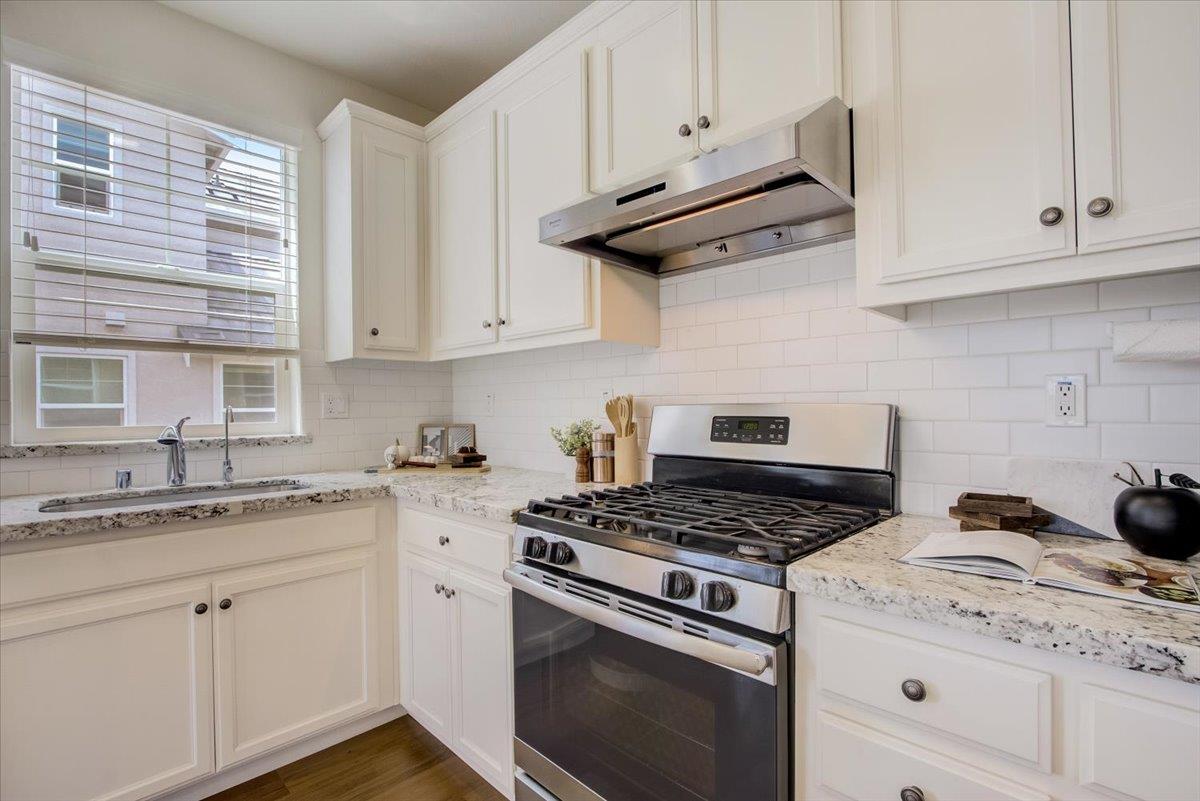 4132 Panorama Drive Dublin, CA 94568 - Photo 15 of 53 a kitchen with stainless steel appliances granite countertop white cabinets and a stove a sink
