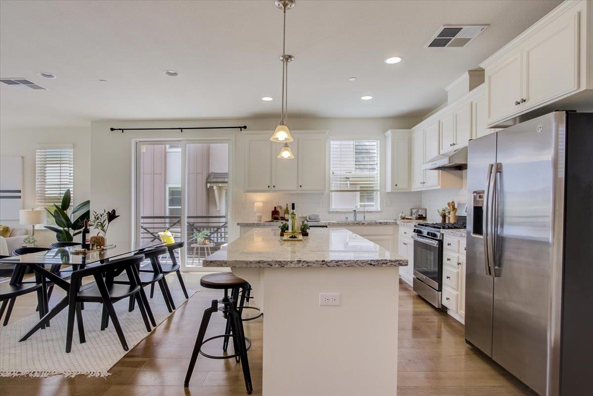 4132 Panorama Drive Dublin, CA 94568 - Photo 8 of 53 a kitchen with refrigerator a sink and chairs