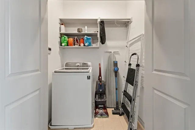 a view of small space with fridge dryer and washer